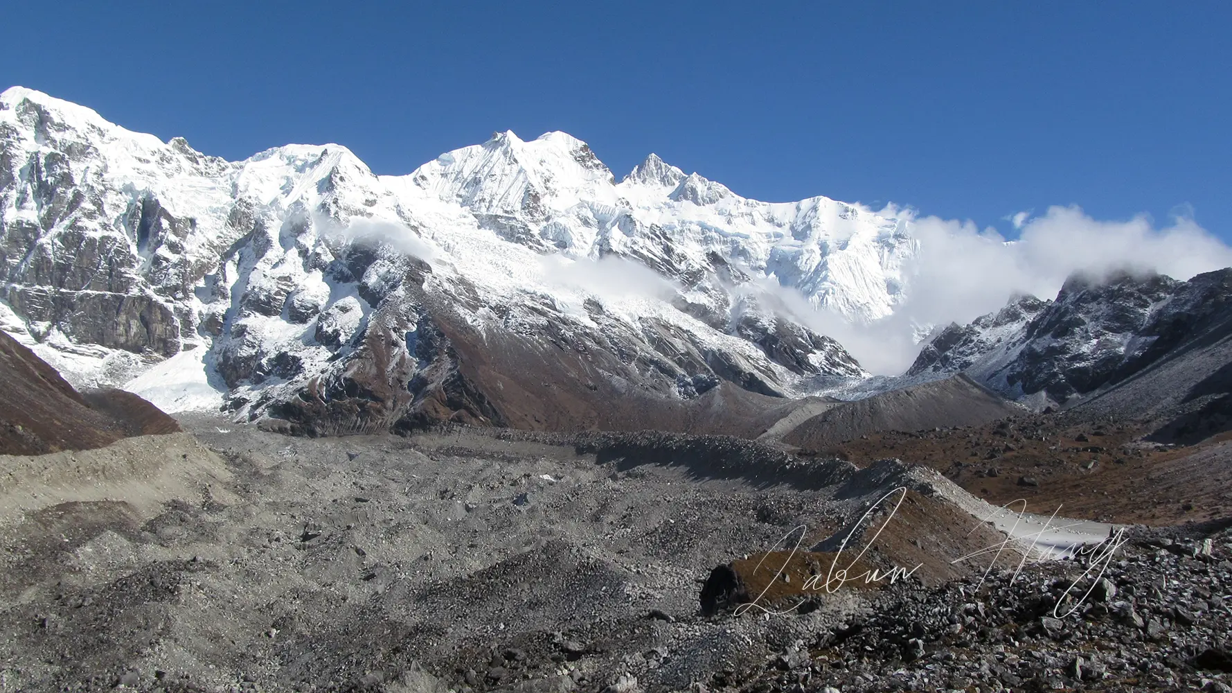 Spectacular view of Kanchenjunga mountain range from Goechala Trek Viewpoint 1 near Yuksom, showing snow-capped peaks and glacial moraine in Sikkim Himalayas
